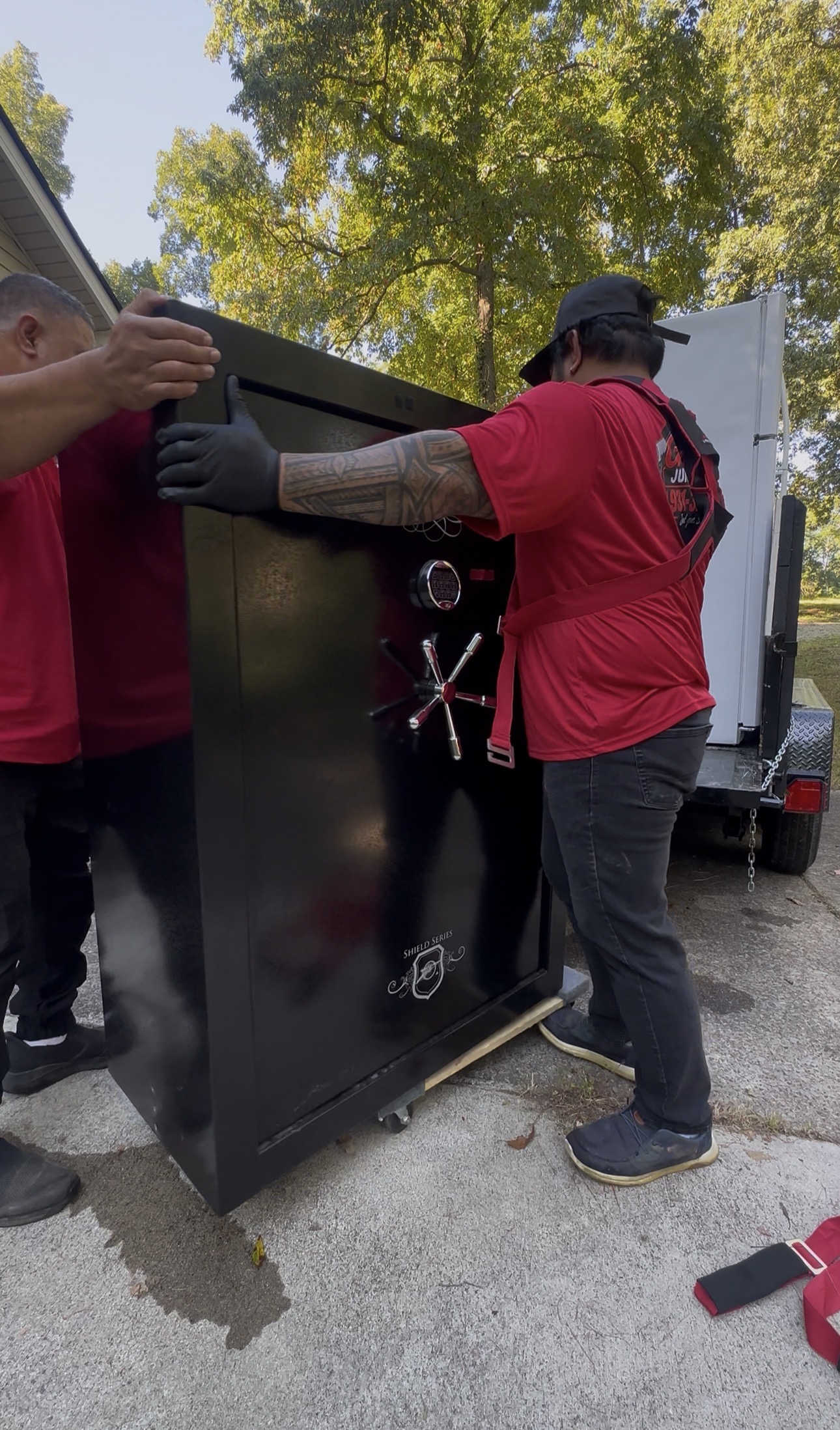 Gracie’s crew removing a large appliance from a home