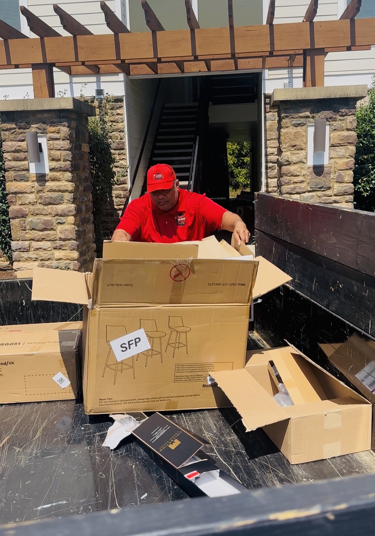 Gracie’s team member handling cardboard at a property
