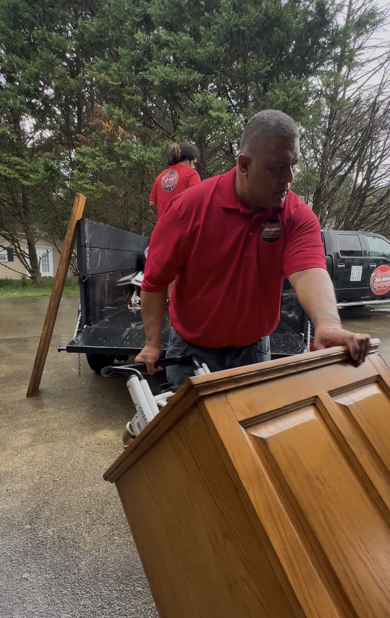 Gracie’s crew carrying a cabinet during a furniture removal