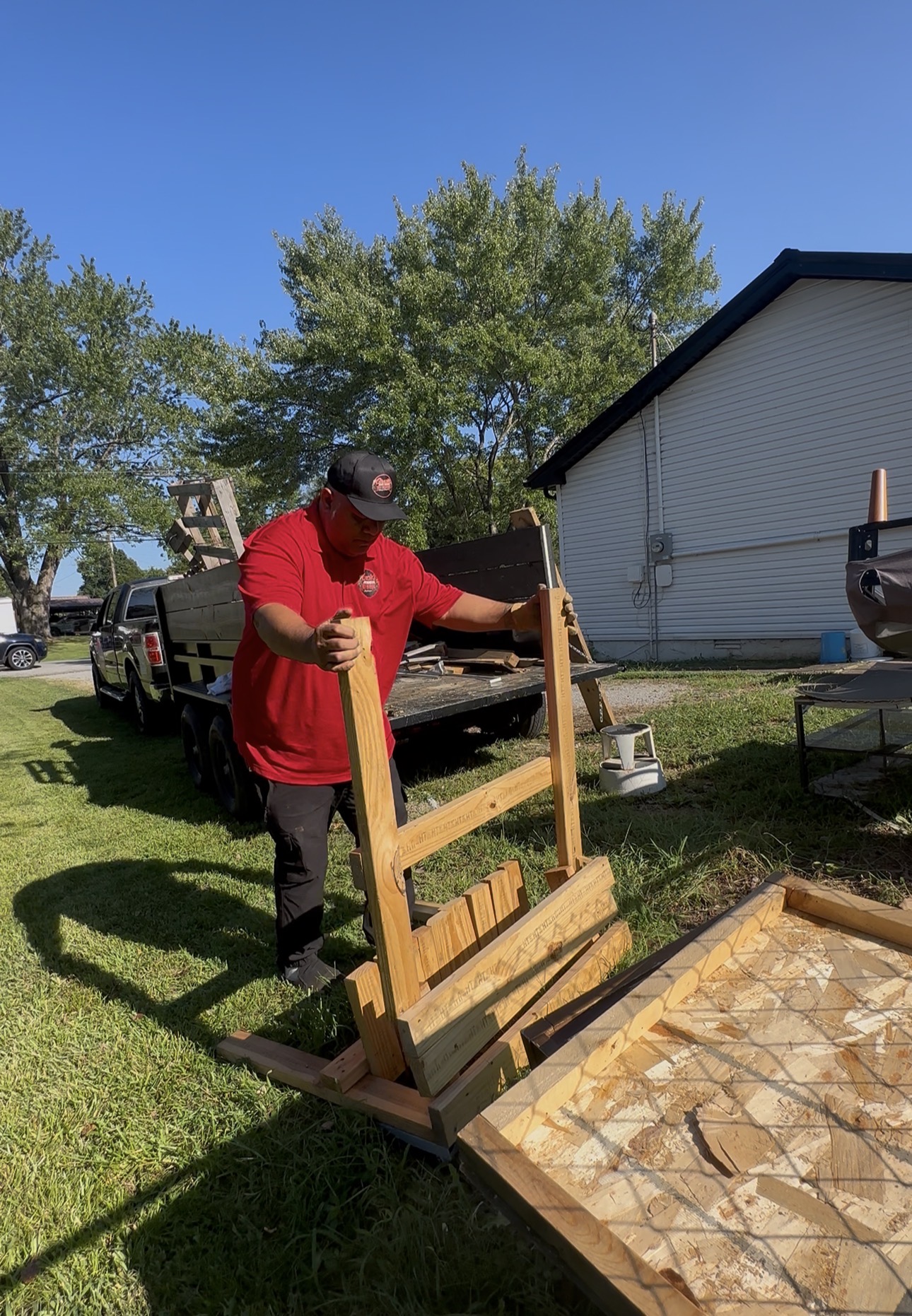 Gracie’s crew moving a large item during an outdoor cleanout