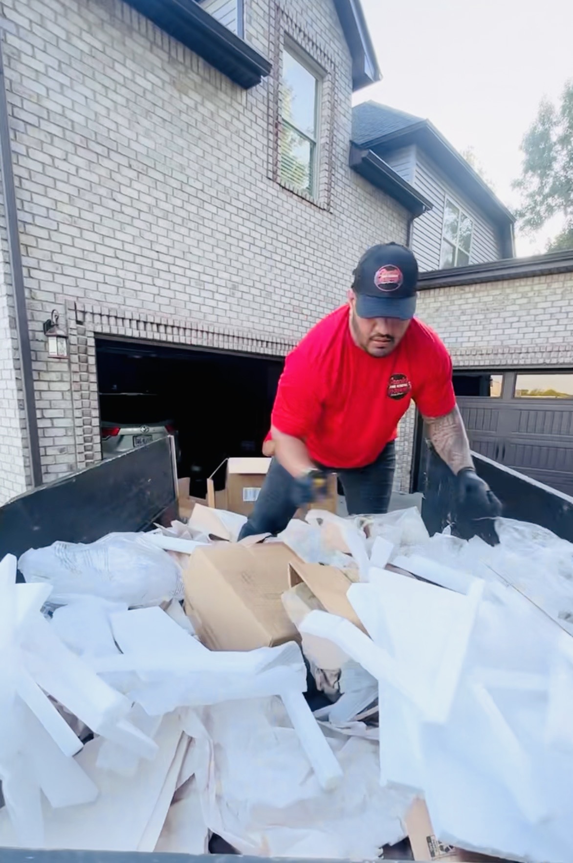 Gracie’s crew loading discarded packing materials